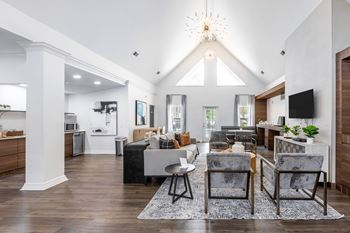 a living room with couches and chairs and a tv